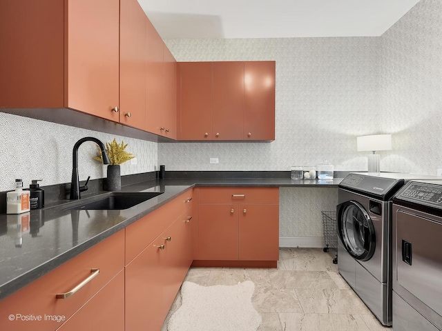 kitchen featuring tasteful backsplash, washer and clothes dryer, and sink