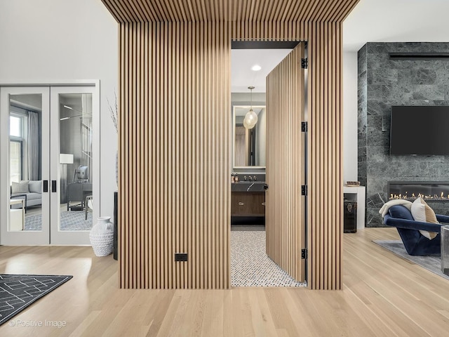 hallway with french doors and wood-type flooring