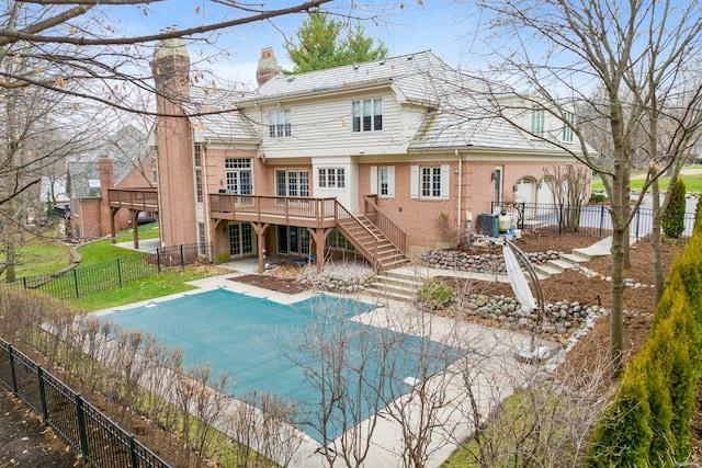 back of house with a pool side deck and a patio area