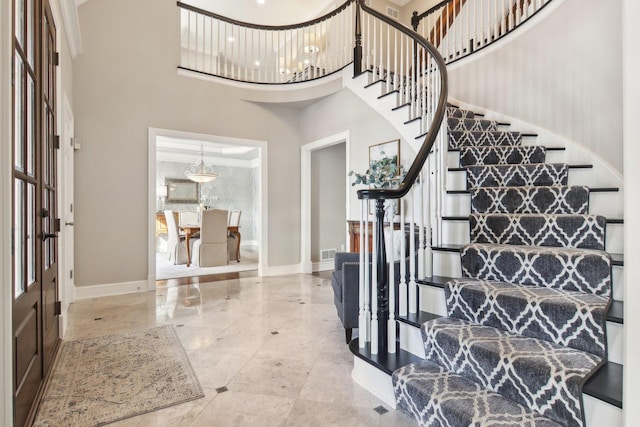 foyer with a towering ceiling and an inviting chandelier