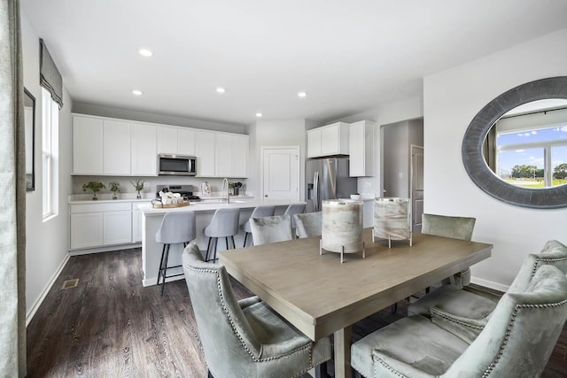 dining area with dark hardwood / wood-style flooring