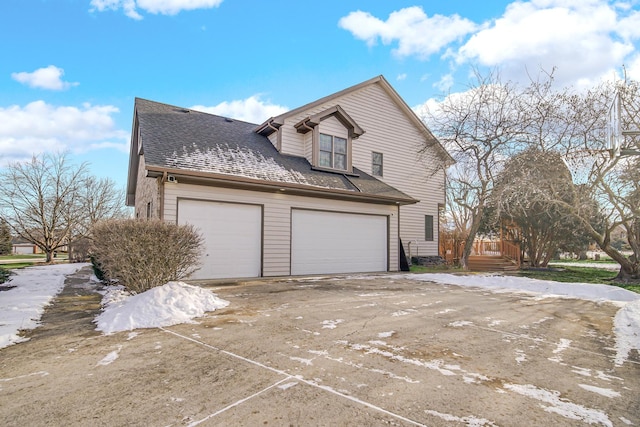 view of side of home with a garage