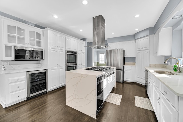 kitchen featuring sink, island exhaust hood, white cabinetry, and wine cooler