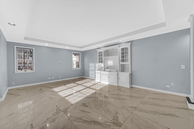 unfurnished room featuring a raised ceiling