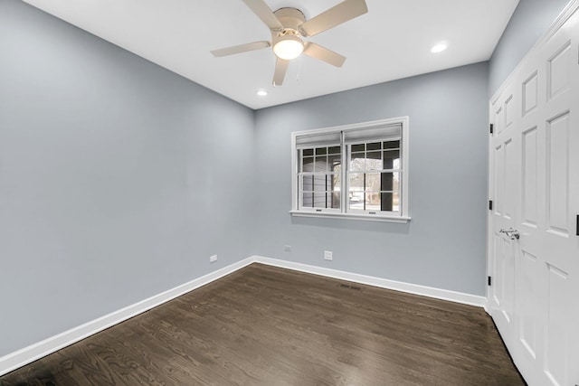 unfurnished room with ceiling fan and dark hardwood / wood-style floors