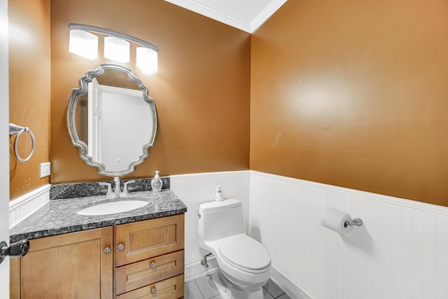 bathroom featuring toilet, vanity, ornamental molding, and tile patterned flooring