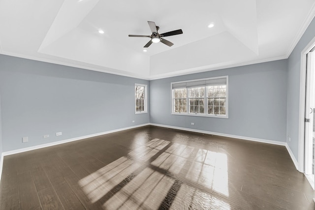 unfurnished room featuring ceiling fan, a raised ceiling, ornamental molding, and dark hardwood / wood-style flooring