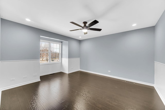 empty room featuring dark hardwood / wood-style floors and ceiling fan