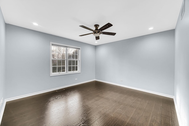 unfurnished room featuring ceiling fan and dark wood-type flooring