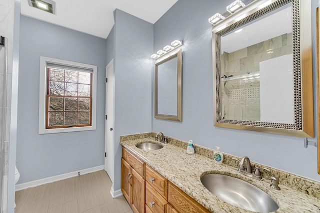 bathroom with toilet, a shower with door, and vanity