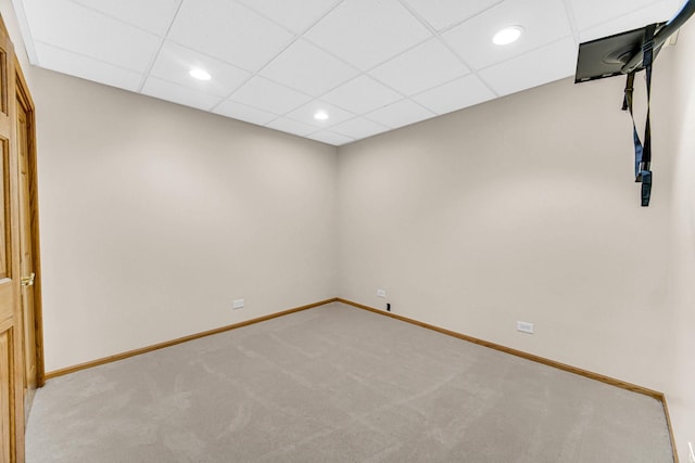 unfurnished room with light carpet and a drop ceiling