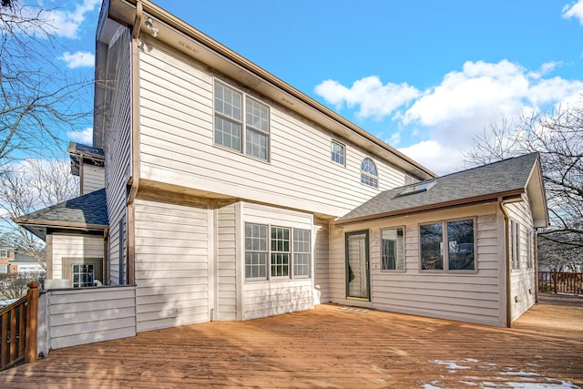 rear view of house featuring a deck