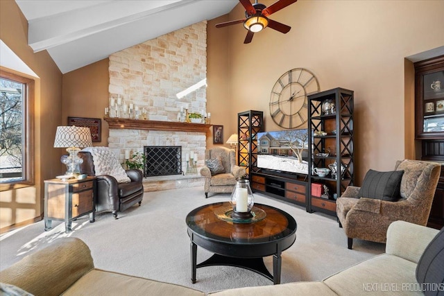 living room with beam ceiling, ceiling fan, a stone fireplace, high vaulted ceiling, and light carpet