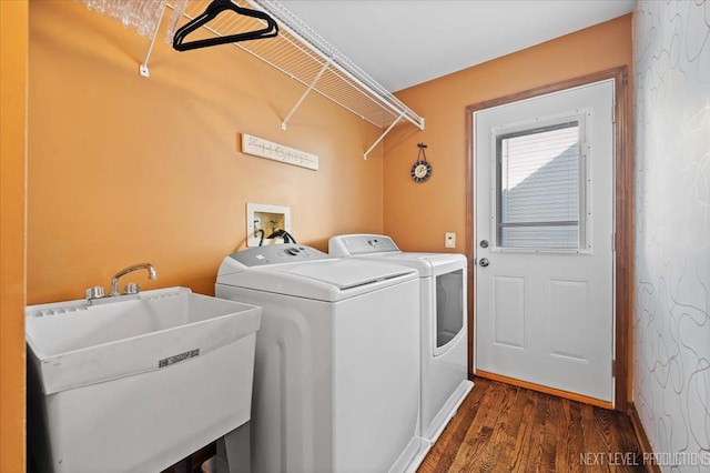 washroom featuring dark hardwood / wood-style flooring, washer and clothes dryer, and sink