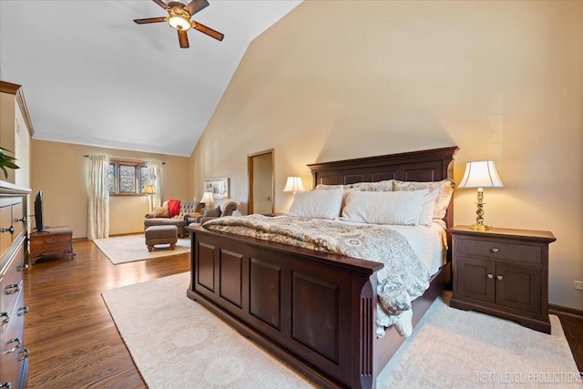 bedroom with ceiling fan, wood-type flooring, and lofted ceiling