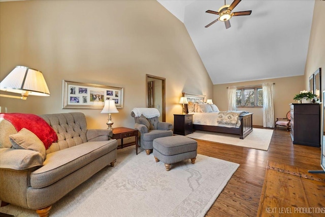 bedroom with dark hardwood / wood-style flooring, high vaulted ceiling, and ceiling fan