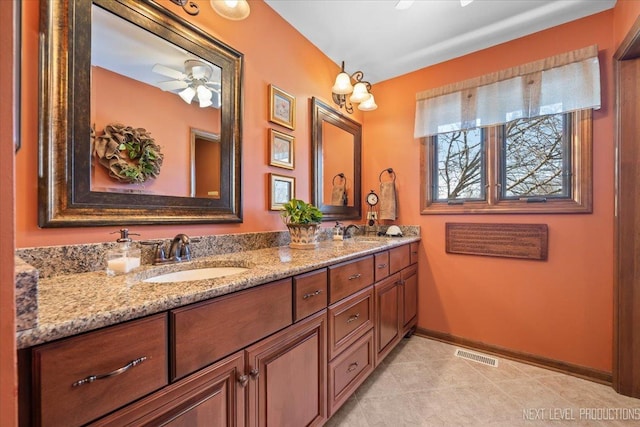 bathroom with ceiling fan and vanity