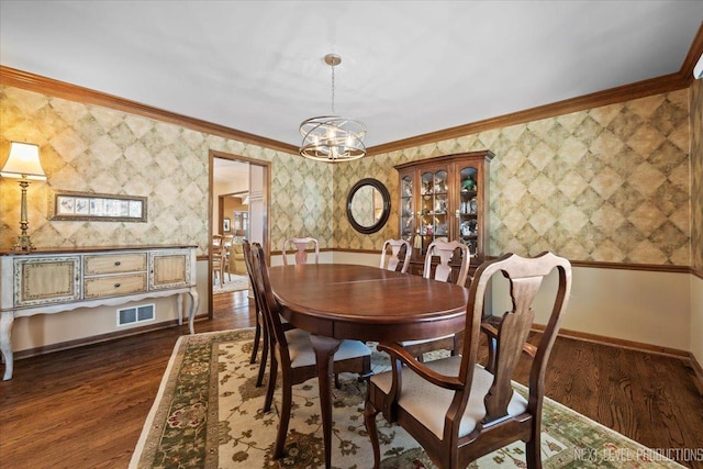 dining space featuring dark hardwood / wood-style floors and crown molding