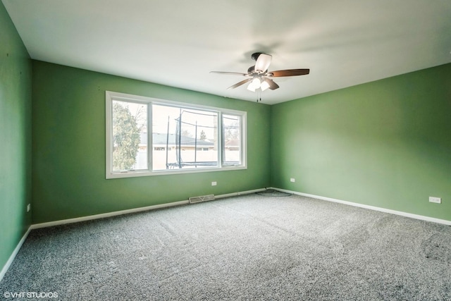 unfurnished room featuring ceiling fan and carpet floors