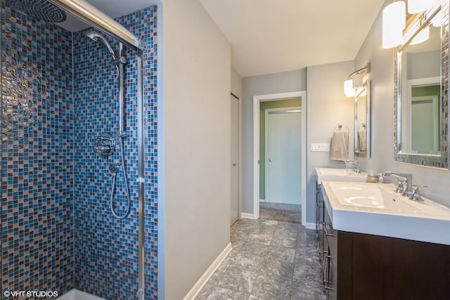 bathroom with vanity and tiled shower