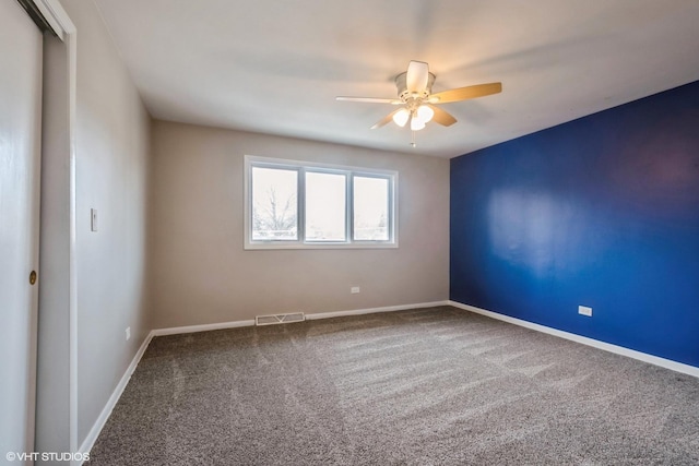 spare room with ceiling fan and carpet floors