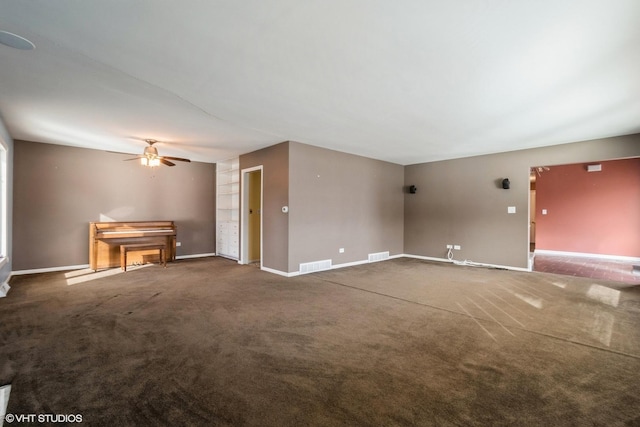 unfurnished living room with dark colored carpet and ceiling fan