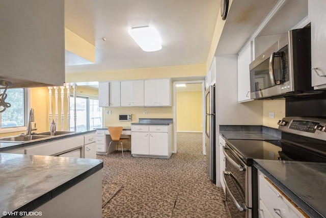 kitchen featuring white cabinetry, sink, and appliances with stainless steel finishes