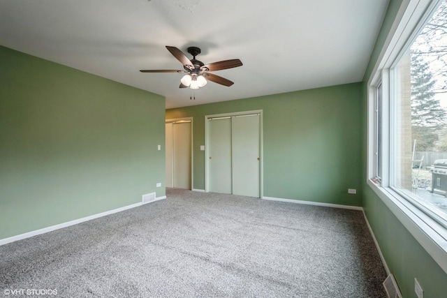 unfurnished bedroom featuring carpet and ceiling fan