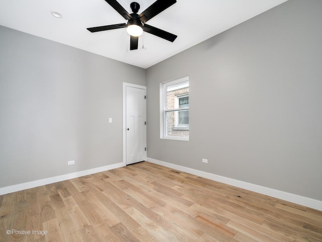 empty room with ceiling fan and light hardwood / wood-style floors