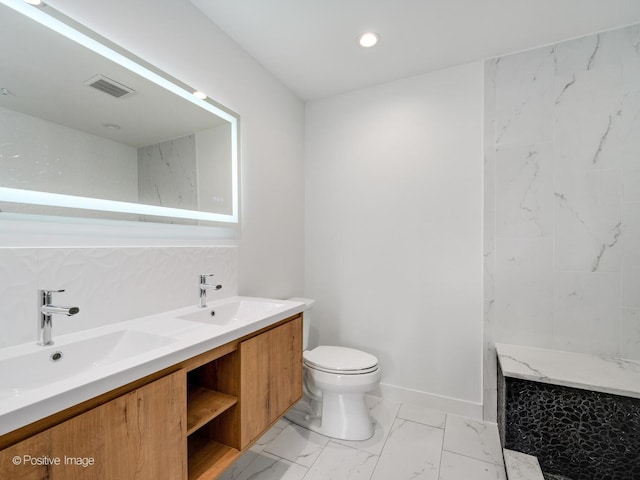 bathroom with decorative backsplash, vanity, and toilet