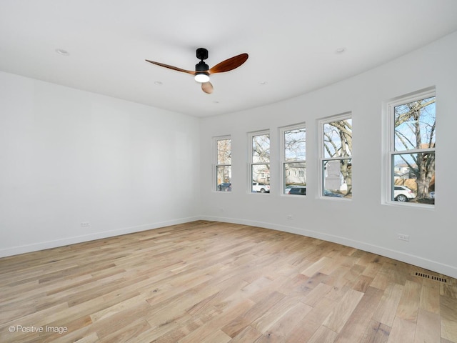 unfurnished room with ceiling fan and light wood-type flooring