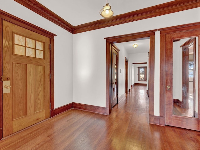 foyer featuring a wealth of natural light, hardwood / wood-style floors, and ornamental molding