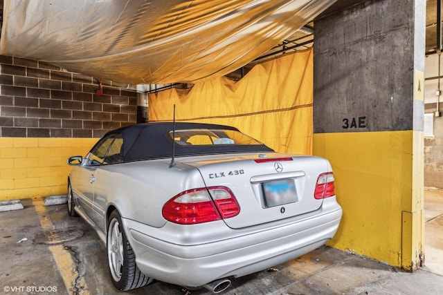 parking deck featuring concrete block wall