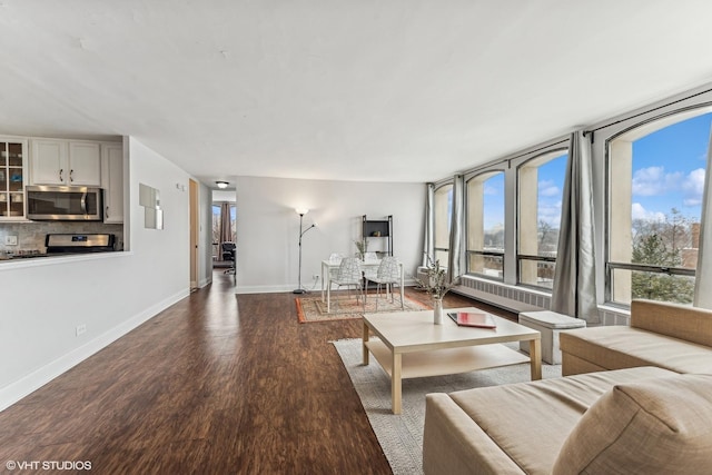 living area with dark wood finished floors and baseboards