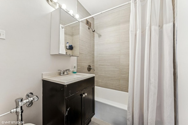 bathroom featuring shower / bath combo with shower curtain and vanity