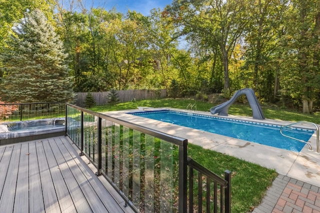 view of pool featuring a hot tub and a water slide