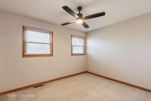 carpeted empty room featuring ceiling fan