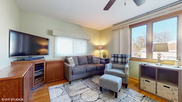 living room featuring light hardwood / wood-style flooring and ceiling fan