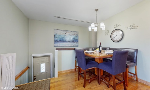 dining space with a chandelier and light wood-type flooring