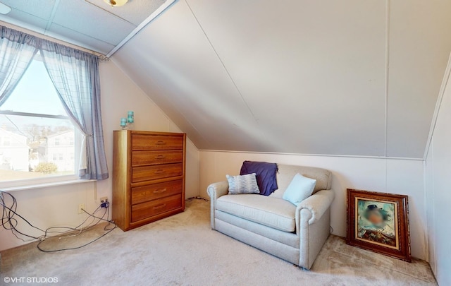 living area featuring light carpet and lofted ceiling