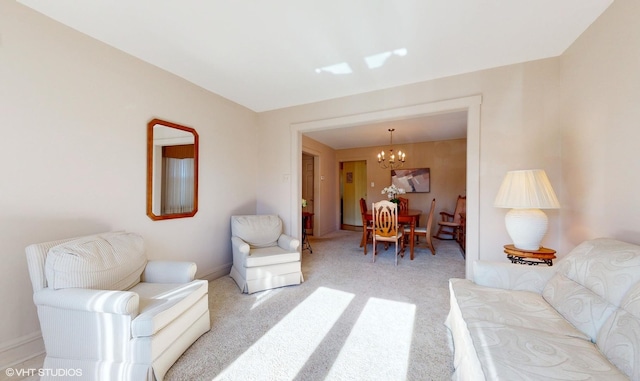 carpeted living room with an inviting chandelier