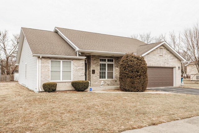 single story home featuring a garage and a front yard