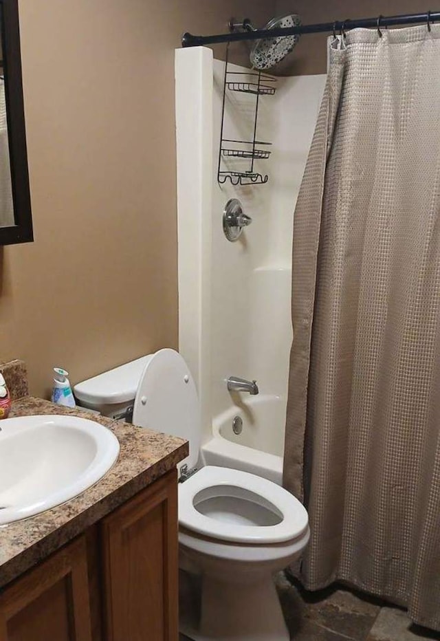 full bathroom with toilet, vanity, and shower / tub combo with curtain