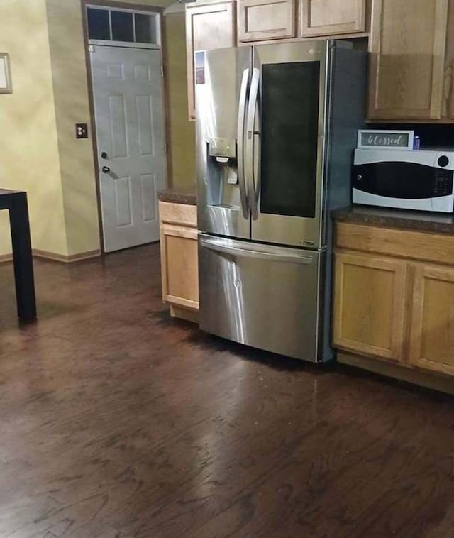 kitchen with stainless steel fridge with ice dispenser and dark hardwood / wood-style flooring