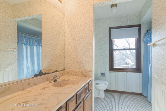 bathroom with tile patterned flooring, vanity, and toilet