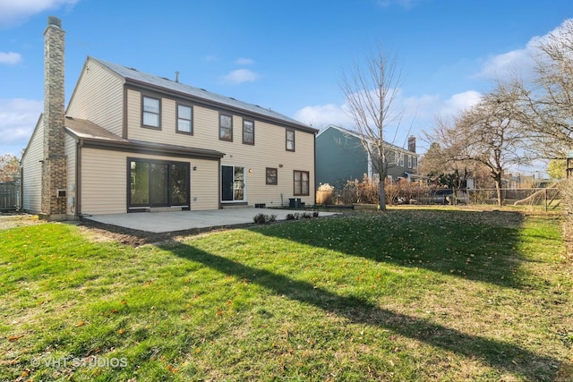 rear view of house with a patio area and a yard