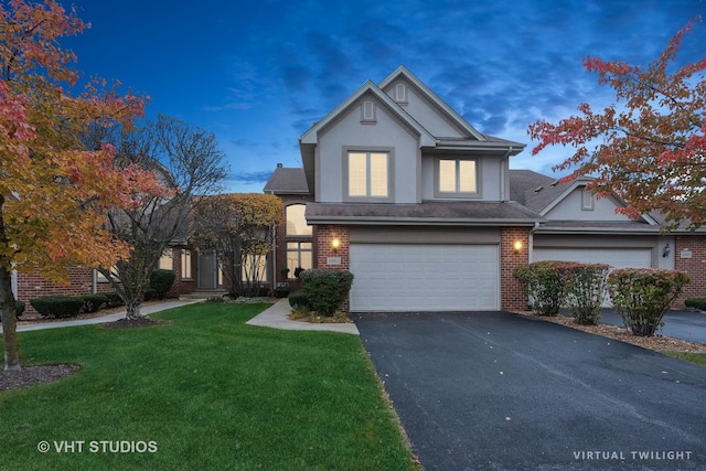 front of property with a yard and a garage