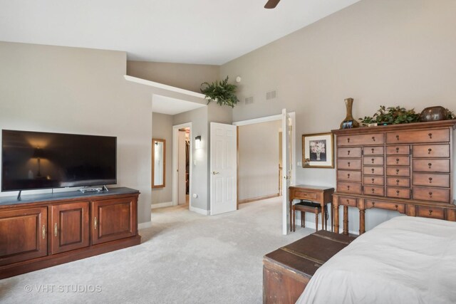 bedroom with light colored carpet, vaulted ceiling, and ceiling fan