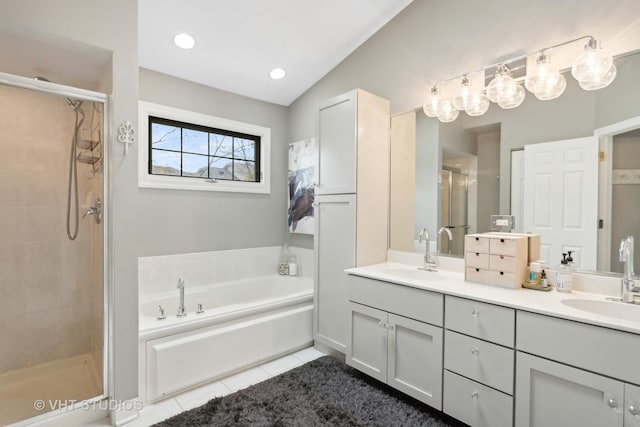 bathroom featuring tile patterned floors, vanity, shower with separate bathtub, and vaulted ceiling