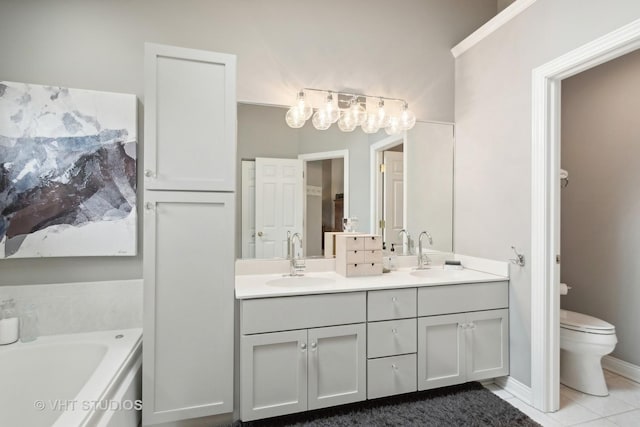 bathroom featuring tile patterned floors, a bathing tub, toilet, and vanity